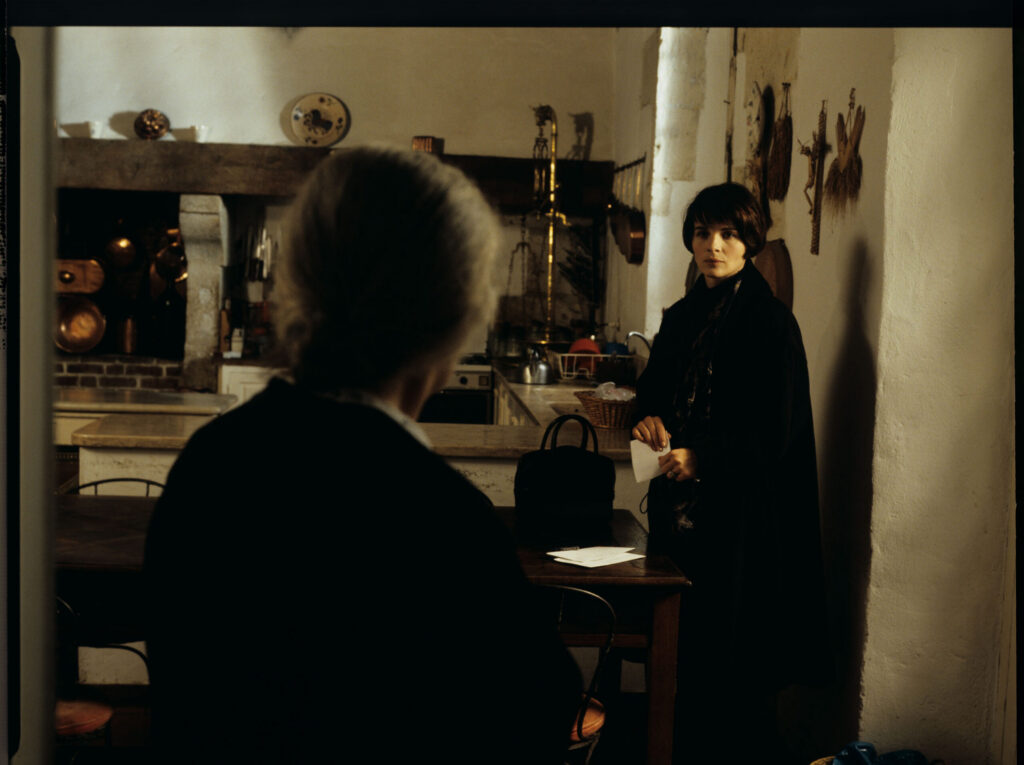 Julie (Binoche), after leaving the hospital, talks to a maid (Isabelle Sadoyan) in the kitchen of her mansion outside Paris.