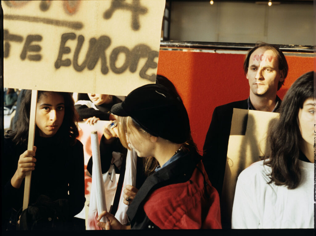 Demonstrators in the café where Julie met Antoine, the boy who witnessed the car accident.