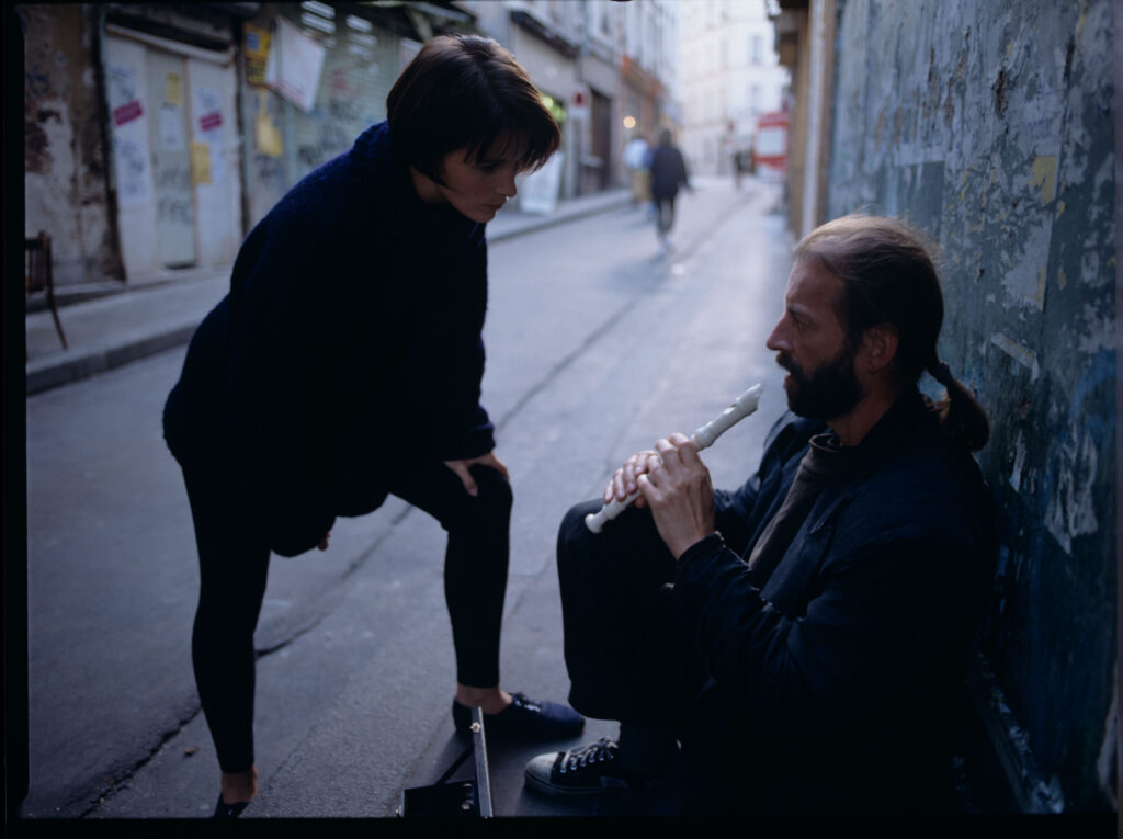 Julie (Juliette Binoche) rozmawia z ulicznym flecistą (w tej roli Jacek Ostaszewski - polski kompozytor i muzyk jazzowy).