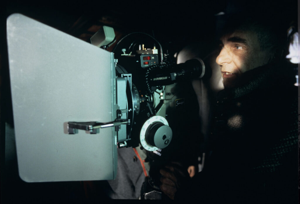 Krzysztof Kieślowski (director) at the camera on the set.