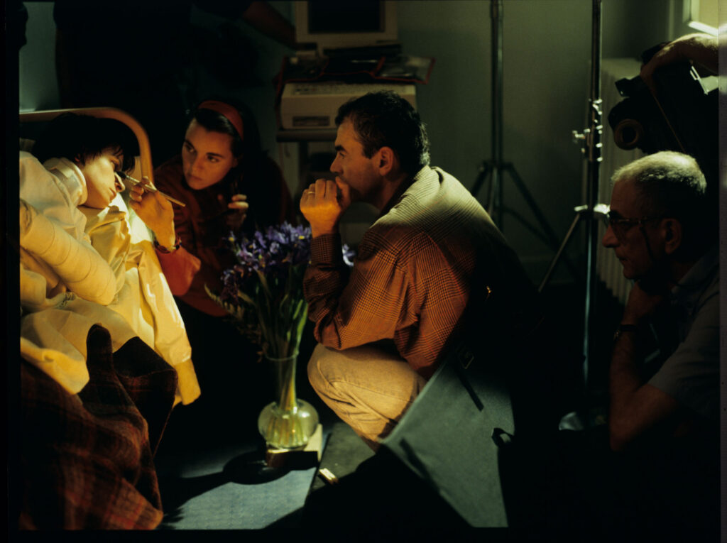 Makeup artist Valerie Tranier prepares Juliette Binoche (as Julie) for filming a scene in the hospital.