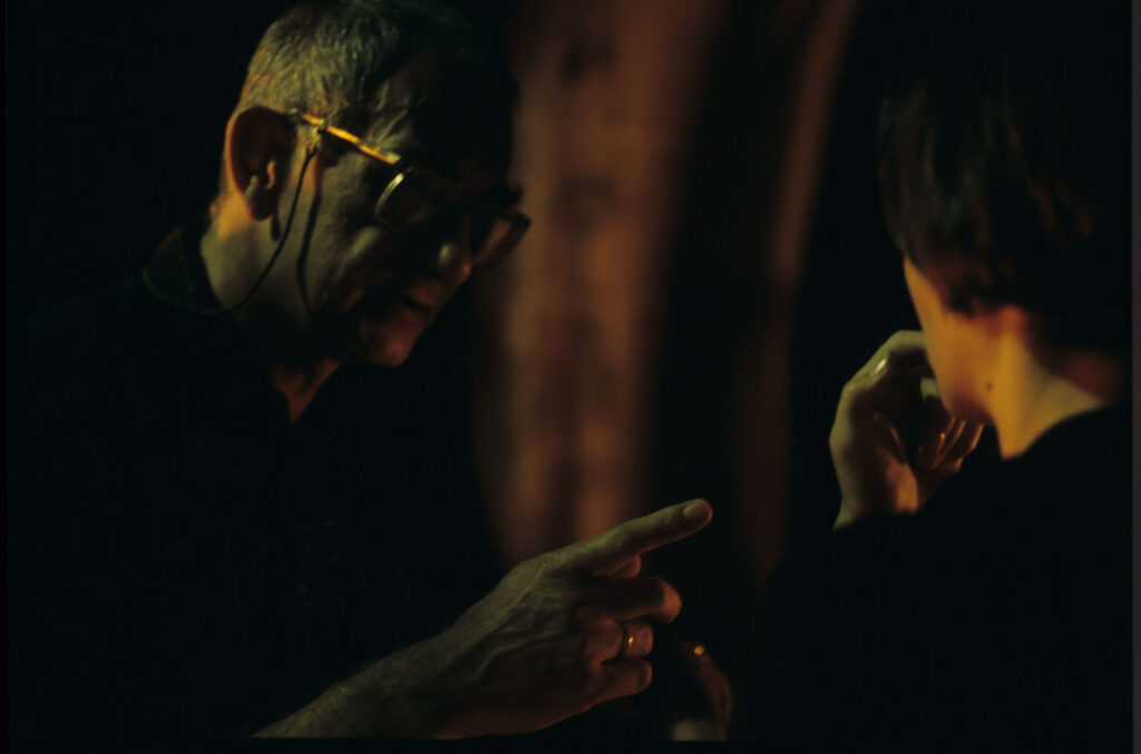 Krzysztof Kieślowski (director) gives directions to actress Juliette Binoche as she prepares for the scene.