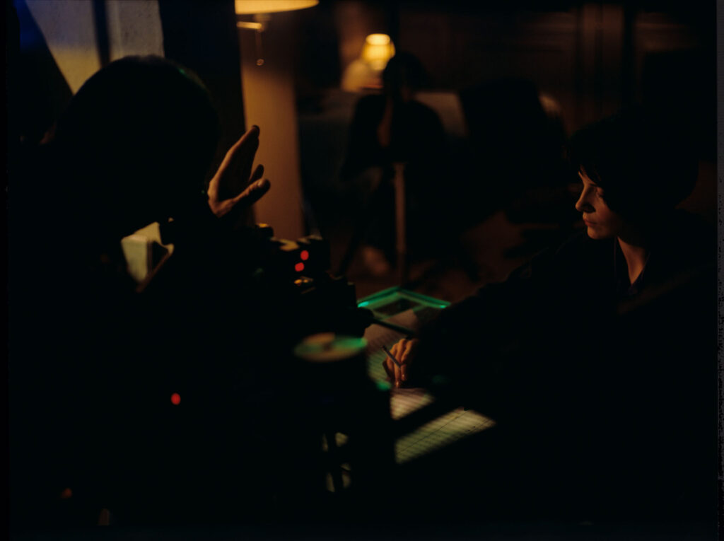 Krzysztof Kieślowski (director) gives directions to actress Juliette Binoche as she prepares for the scene.