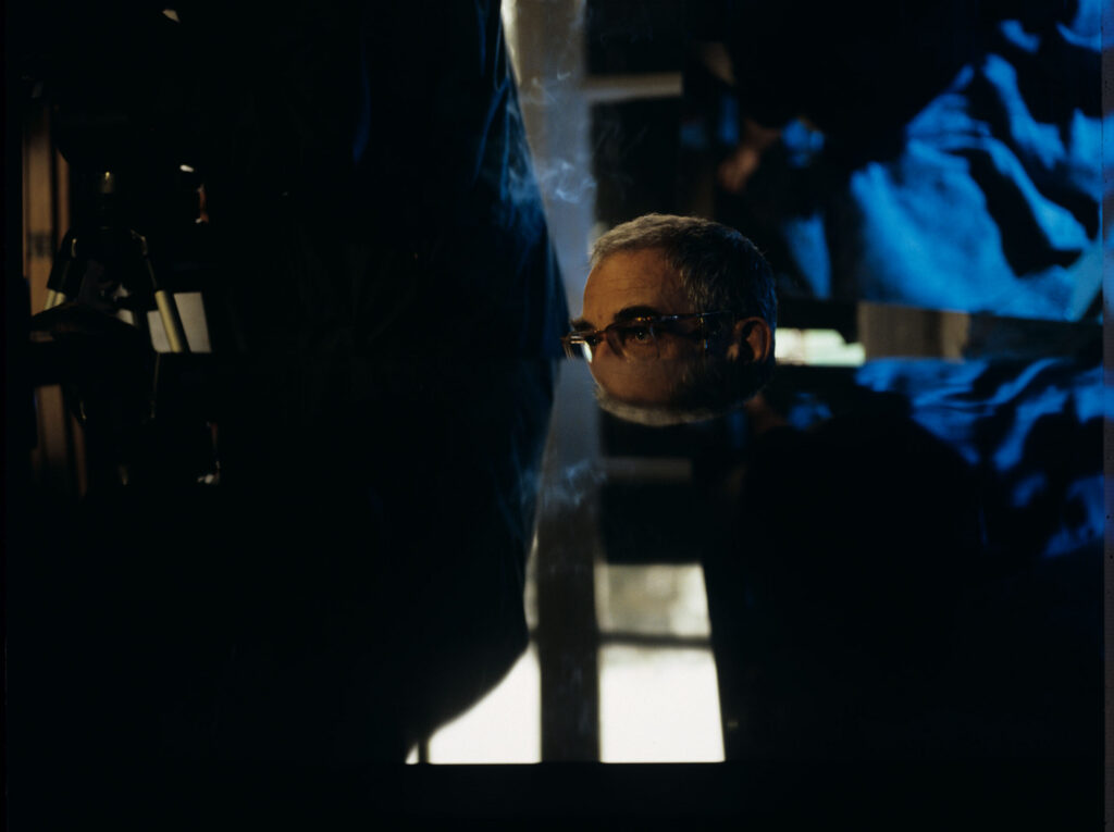 Krzysztof Kieślowski (director) at the piano - an important prop in this part of the trilogy.
