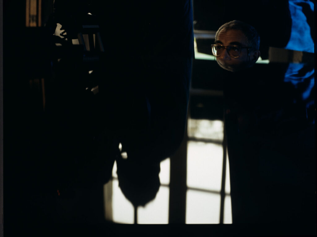 Krzysztof Kieślowski (director) at the piano - an important prop in this part of the trilogy.