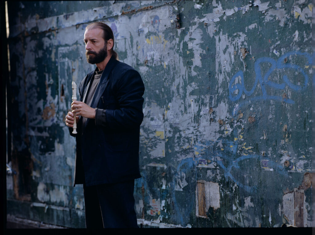 Street flute player (played by Jacek Ostaszewski - Polish composer and jazz musician).