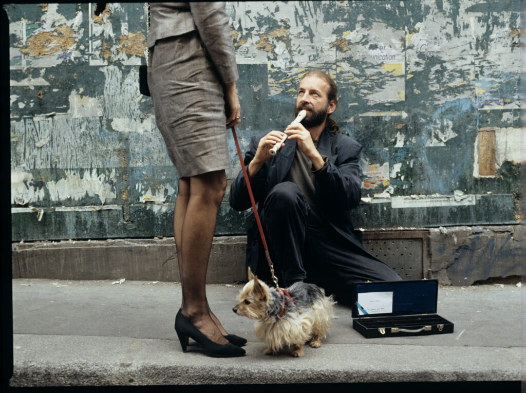 Street flute player (played by Jacek Ostaszewski - Polish composer and jazz musician).