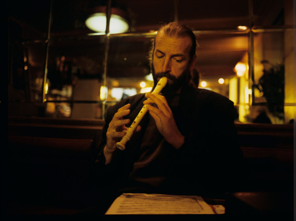 Street flute player (played by Jacek Ostaszewski - Polish composer and jazz musician).
