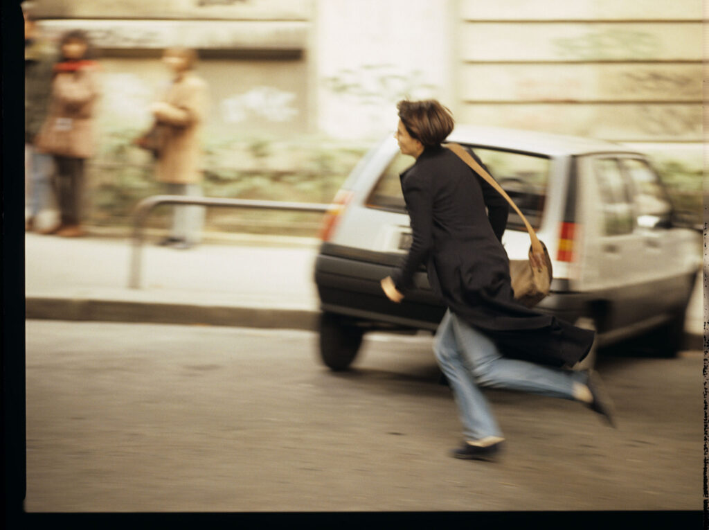 Julie (Juliette Binoche) running after the car of Olivier, a co-worker of her tragically deceased husband.