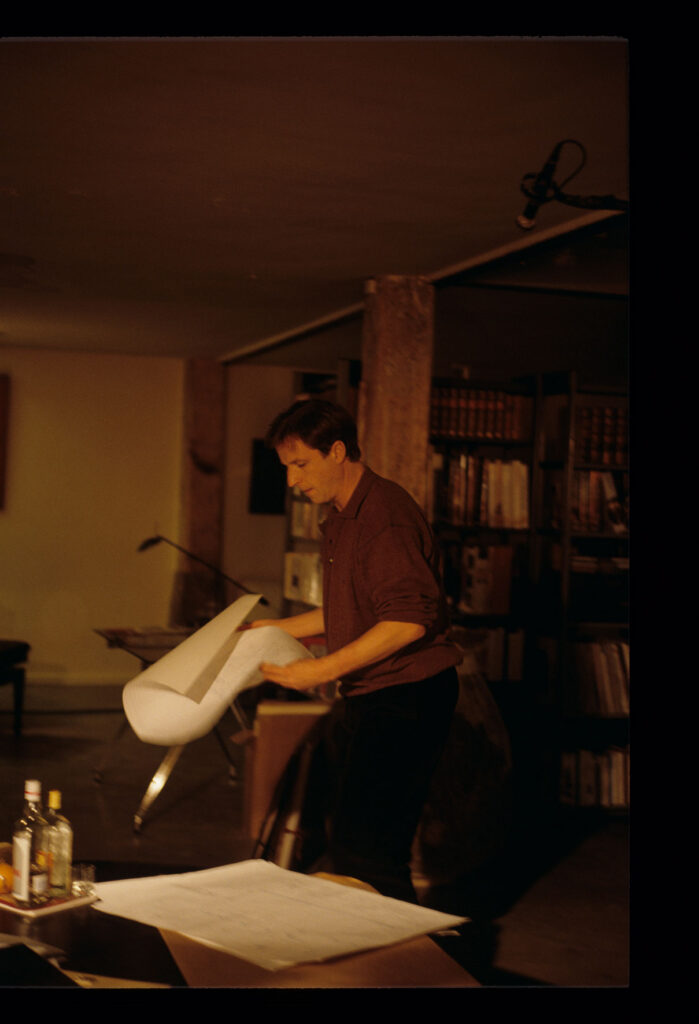 Olivier (Benoit Regent), in his apartment, looks through sheet music composed by the deceased Patrice de Courcy.