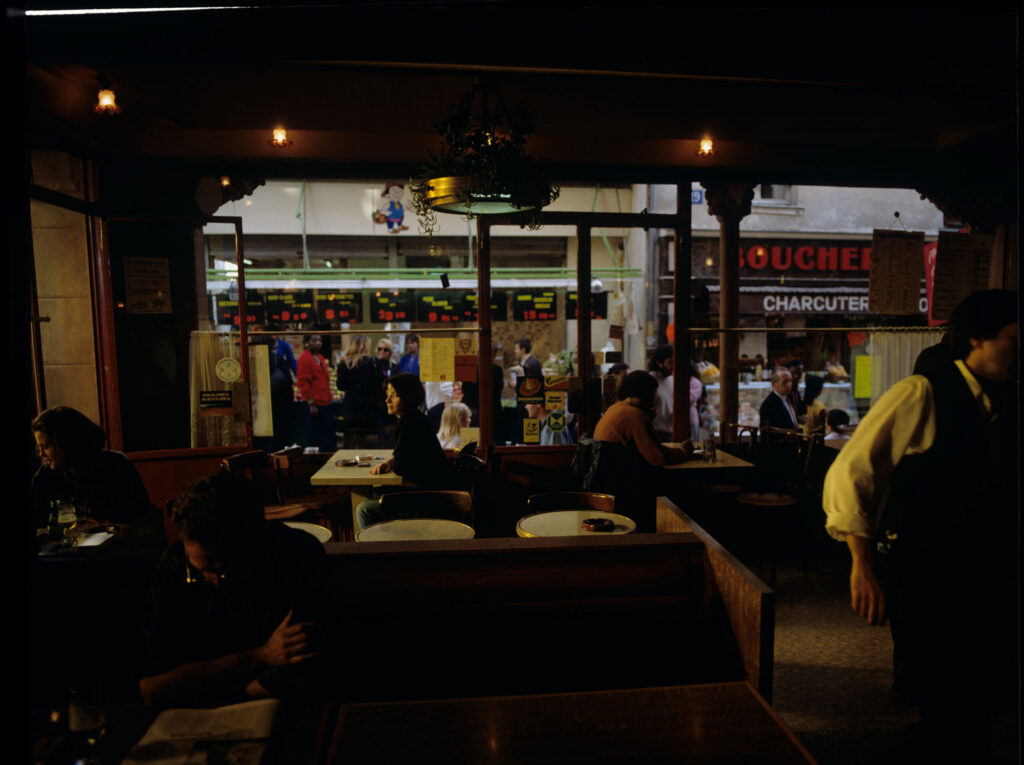 Julie (Juliette Binoche) in the café where she has been visiting every day since she moved to Paris.
