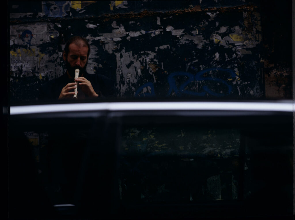Street flute player (played by Jacek Ostaszewski - Polish composer and jazz musician)