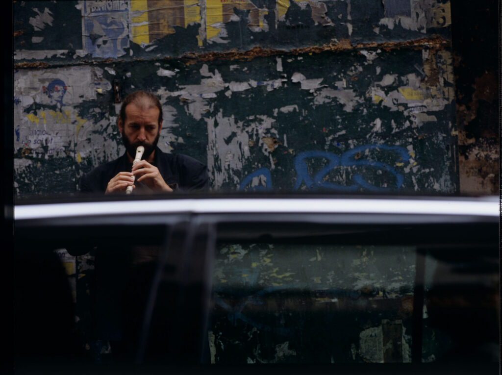 Street flute player (played by Jacek Ostaszewski - Polish composer and jazz musician)