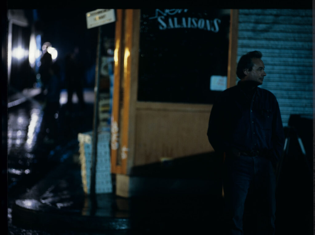 A scene of a street fight which the terrified Julie observes through the window of her apartment.