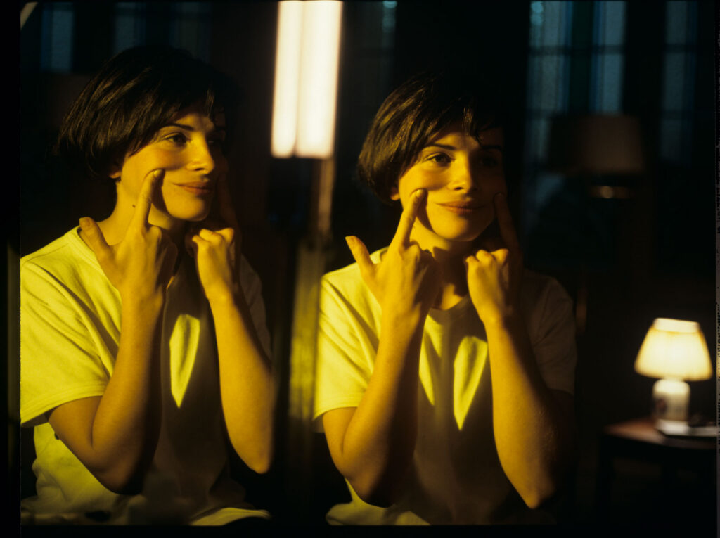 Julie, the main character of the film (Juliette Binoche), looks at her reflection in the mirror.