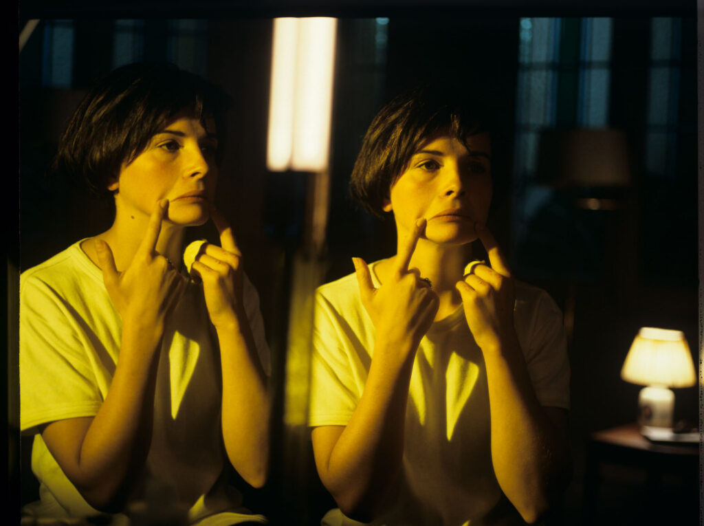 Julie, the main character of the film (Juliette Binoche), looks at her reflection in the mirror.