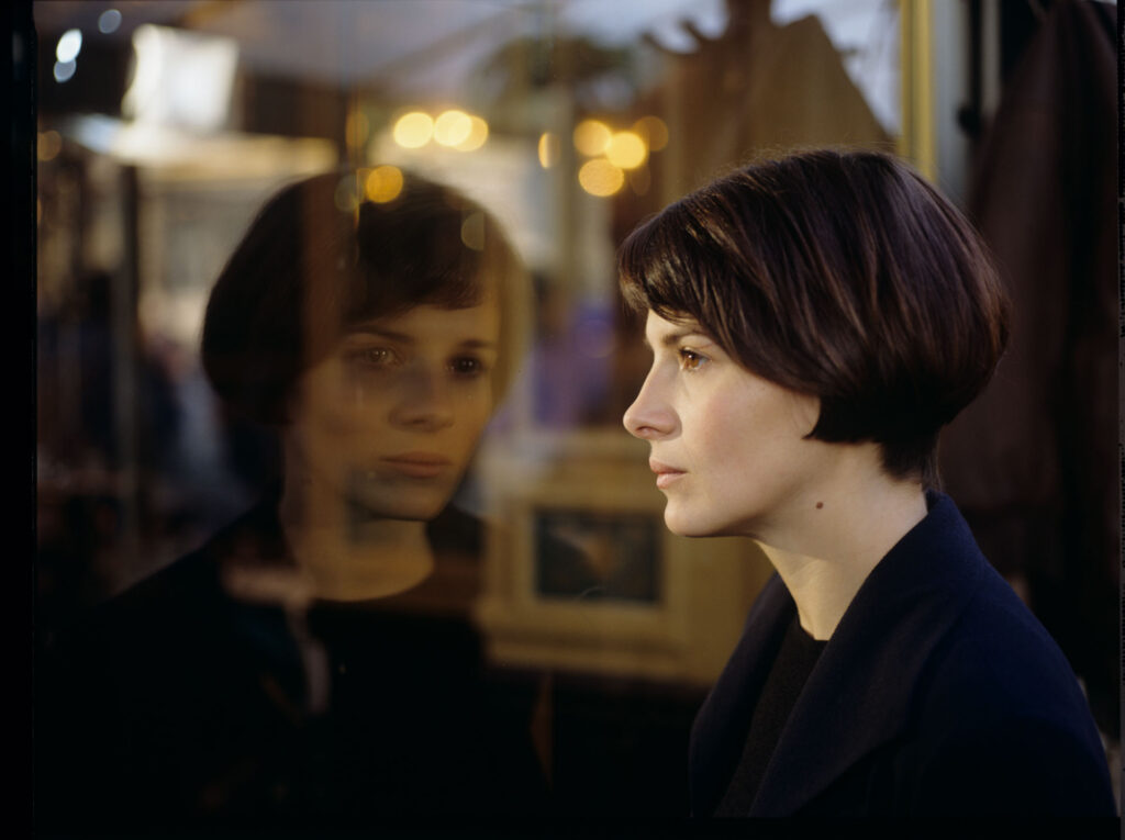 Julie (Juliette Binoche) watches a raindrop drip down the window.