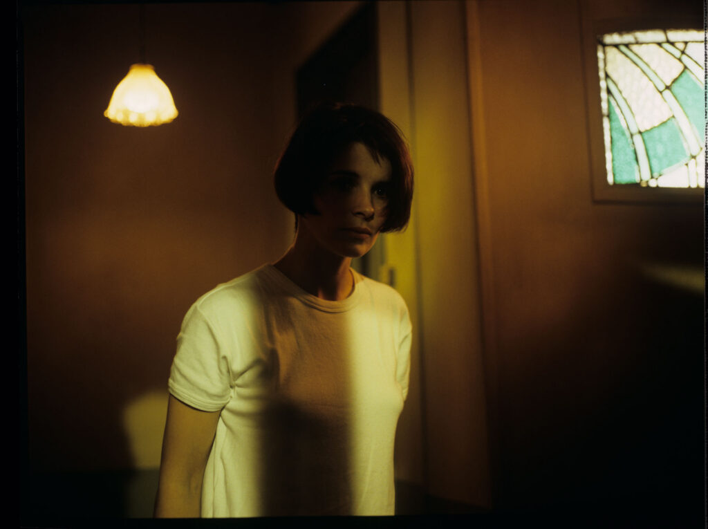 Concerned by noises, Julie (Juliette Binoche) leaves the apartment and accidentally slams the door behind her.