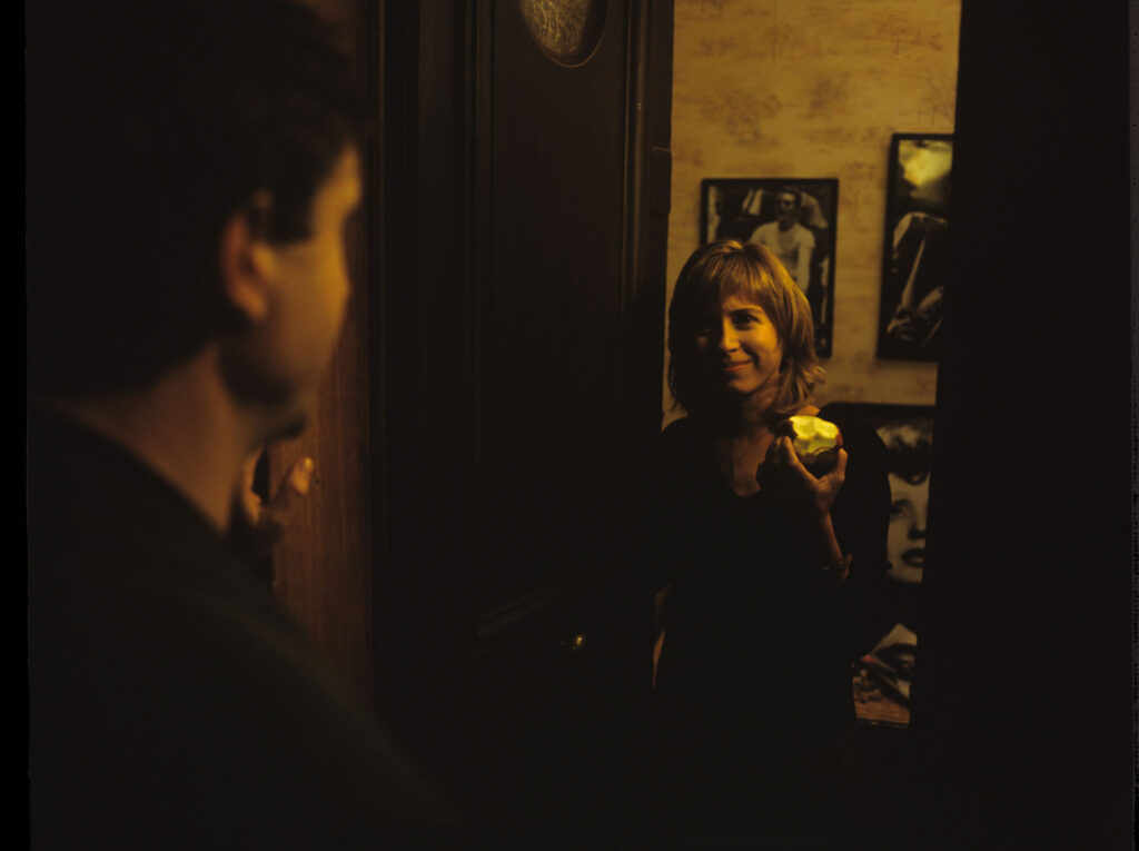 Lucille (Charlotte Very) opens the door to a visiting man.