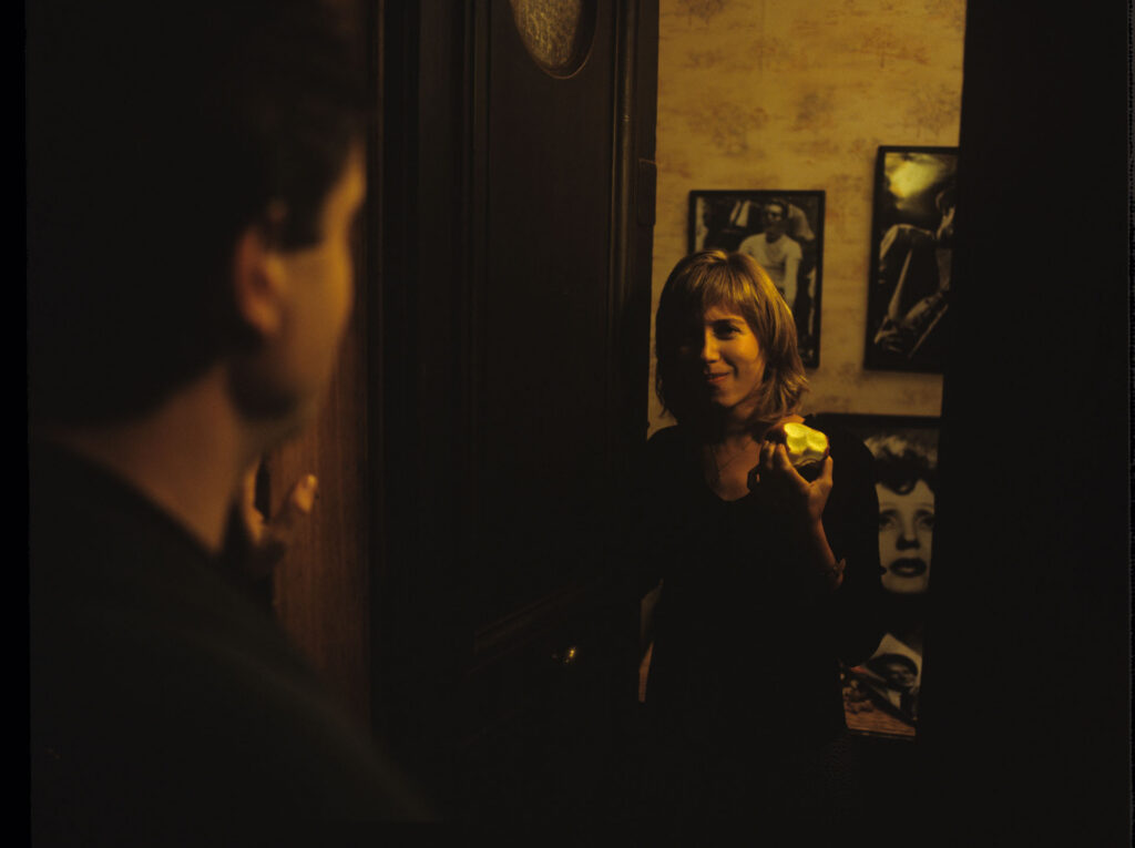 Lucille (Charlotte Very) opens the door to a visiting man.