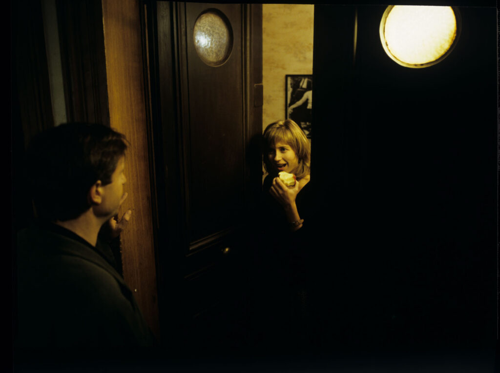 Lucille (Charlotte Very) opens the door to a visiting man.