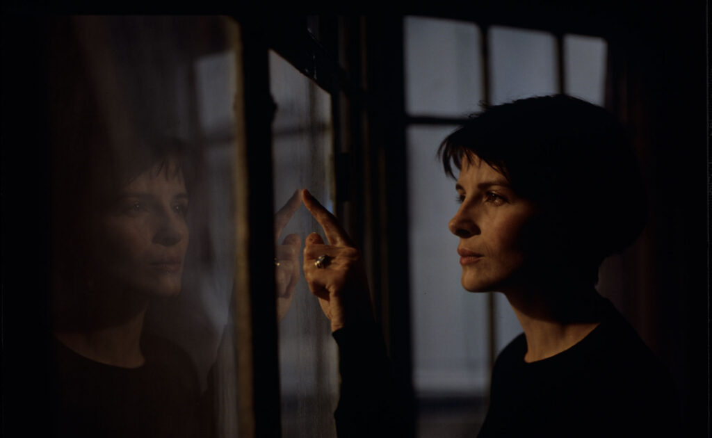 Julie (Juliette Binoche) watches a raindrop drip down the window.