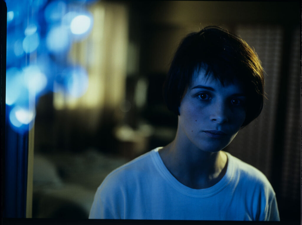 Fotos presenting the main character Julie (Juliette Binoche) with the blue chandellier in the background.