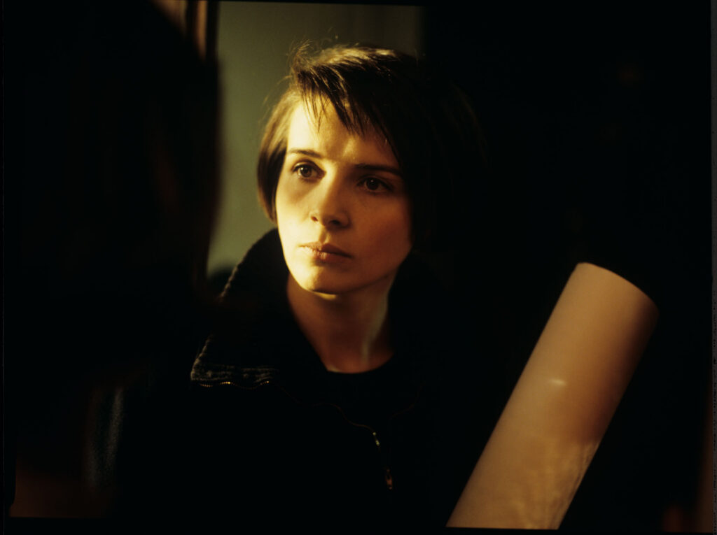 Julie (Juliette Binoche) with rolled up notes with her tragically deceased husband's unfinished composition