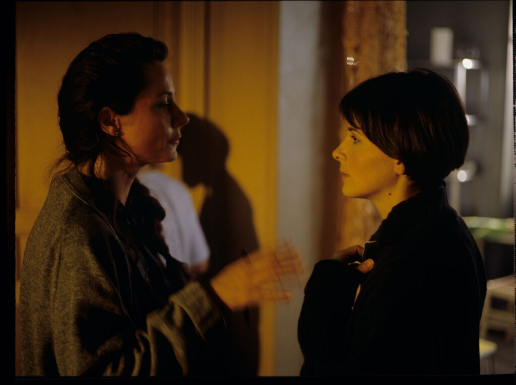 Julie (Juliette Binoche) with her neighbor (Catherine Therouenne) collecting signatures for a petition.
