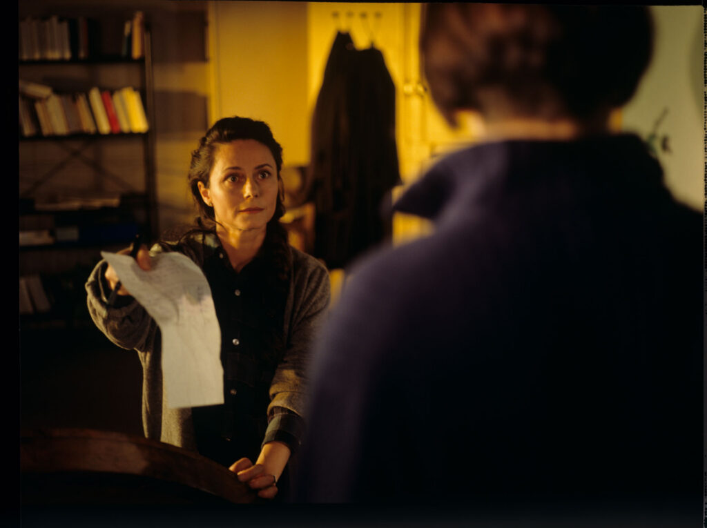 Julie (Juliette Binoche) with her neighbor (Catherine Therouenne) collecting signatures for a petition.