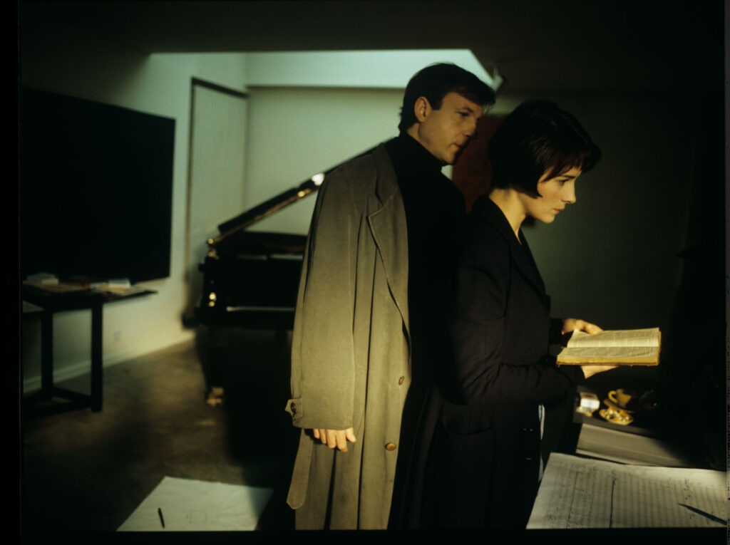 Julie (Juliette Binoche) and Olivier (Benoit Regent) working on finishing Patrice's, Julie's husband, composition.