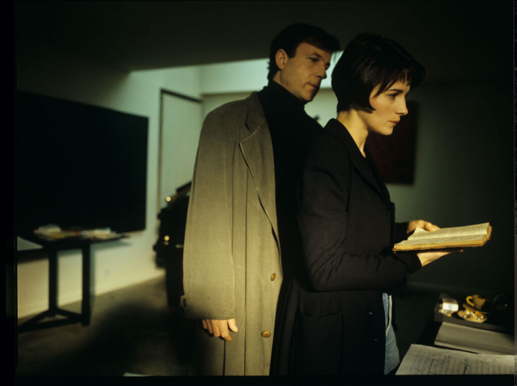Julie (Juliette Binoche) and Olivier (Benoit Regent) working on finishing Patrice's, Julie's husband, composition.