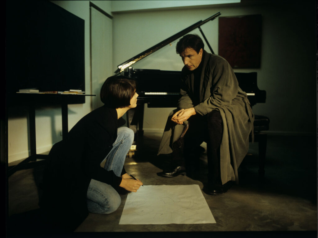 Julie (Juliette Binoche) and Olivier (Benoit Regent) working on finishing Patrice's, Julie's husband, composition.