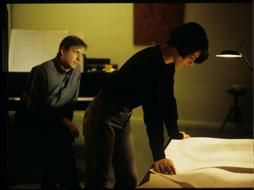 Julie (Juliette Binoche) and Olivier (Benoit Regent) working on finishing Patrice's, Julie's husband, composition.