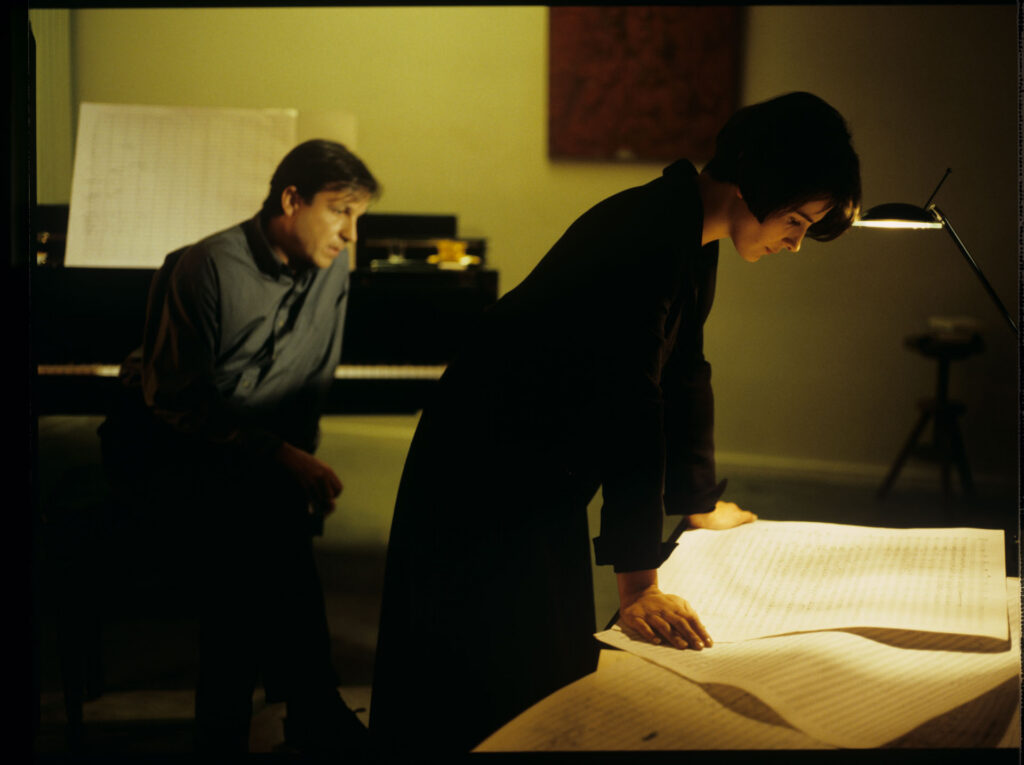 Julie (Juliette Binoche) and Olivier (Benoit Regent) working on finishing Patrice's, Julie's husband, composition.