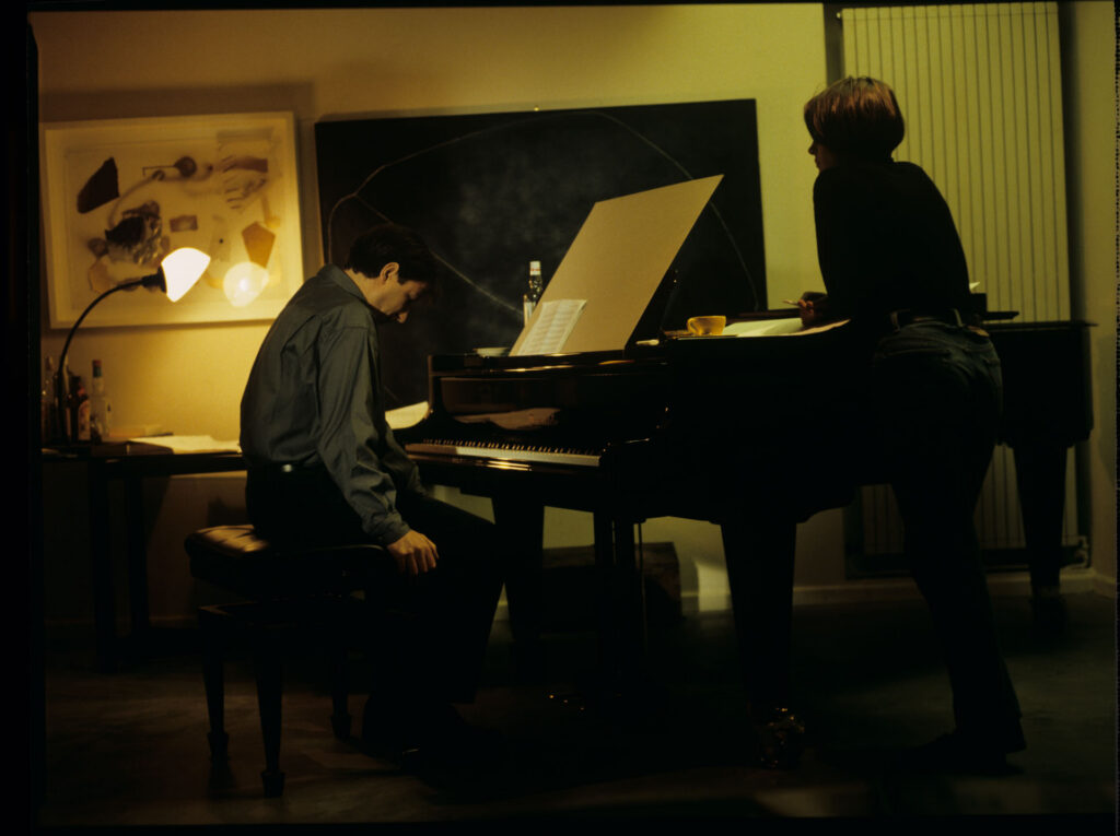 Julie (Juliette Binoche) and Olivier (Benoit Regent) working on finishing Patrice's, Julie's husband, composition.
