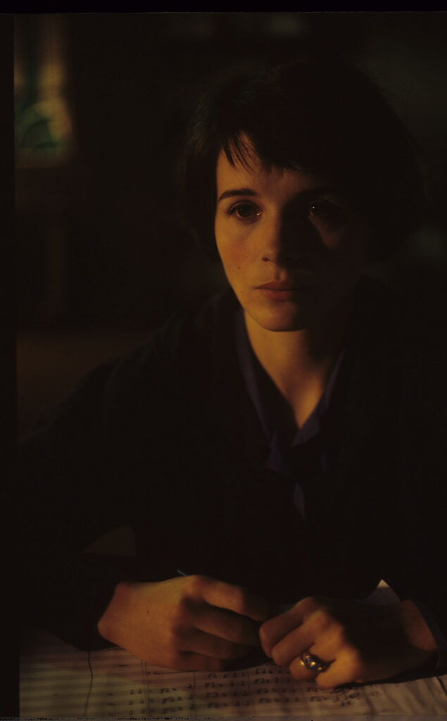 Julie (Juliette Binoche) and Olivier (Benoit Regent) working on finishing Patrice's, Julie's husband, composition.
