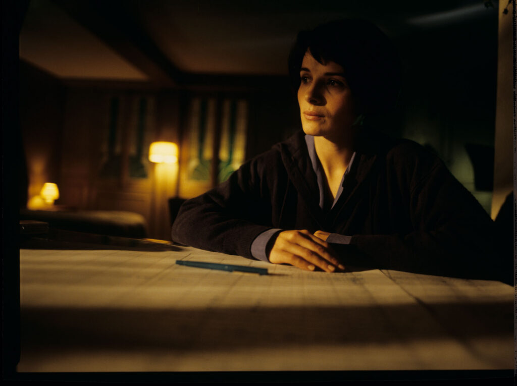 Julie (Juliette Binoche) and Olivier (Benoit Regent) working on finishing Patrice's, Julie's husband, composition.