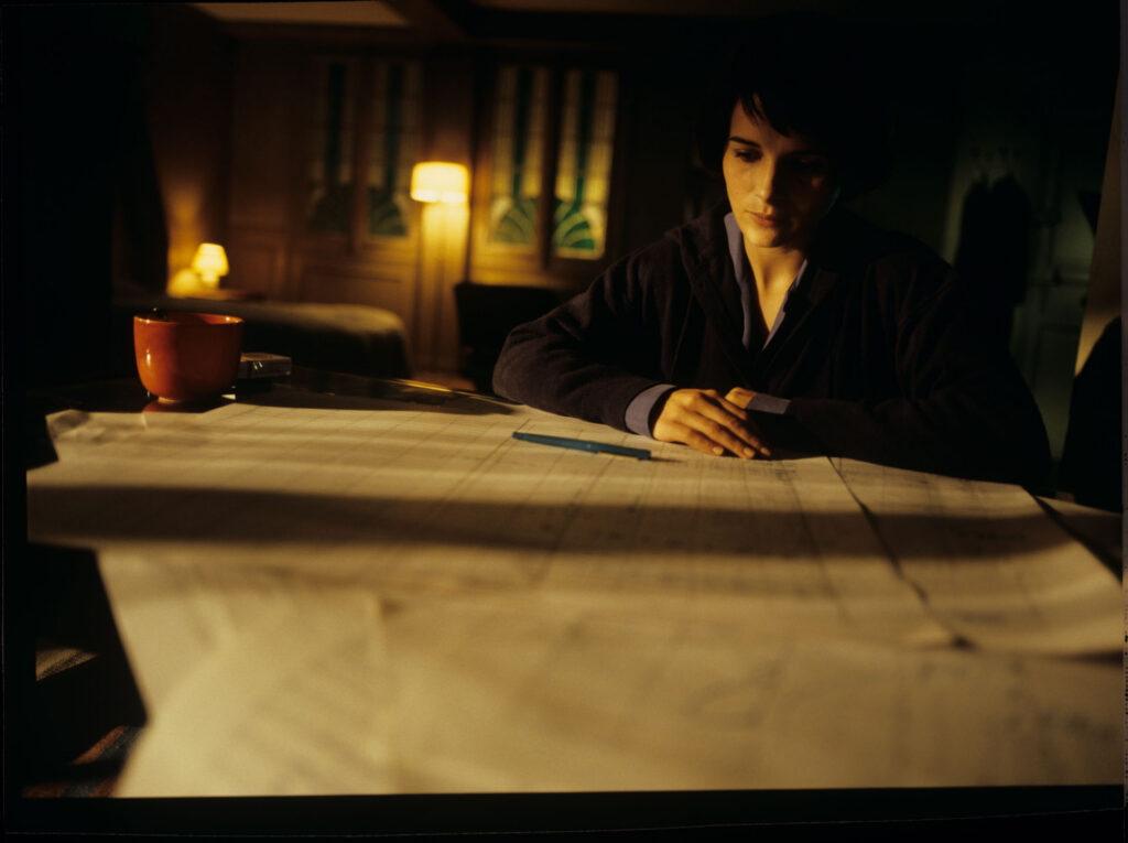 Julie (Juliette Binoche) and Olivier (Benoit Regent) working on finishing Patrice's, Julie's husband, composition.