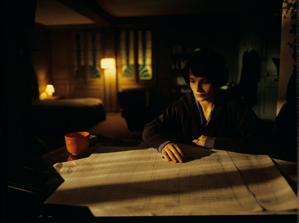Julie (Juliette Binoche) and Olivier (Benoit Regent) working on finishing Patrice's, Julie's husband, composition.
