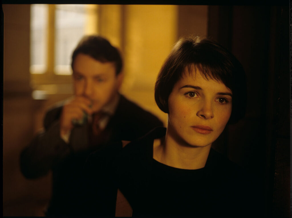 Julie (Juliette Binoche) lights a cigarette in the hall of the Palace of Justice in Paris.