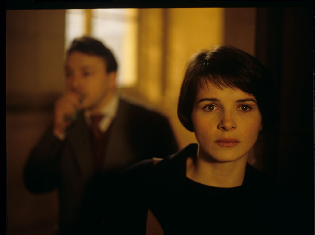 Julie (Juliette Binoche) lights a cigarette in the hall of the Palace of Justice in Paris.