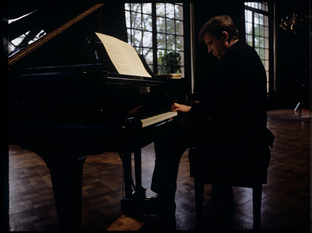 Olivier (Benoit Regent) at the piano in Patrice de Courcy's office at the music conservatory.