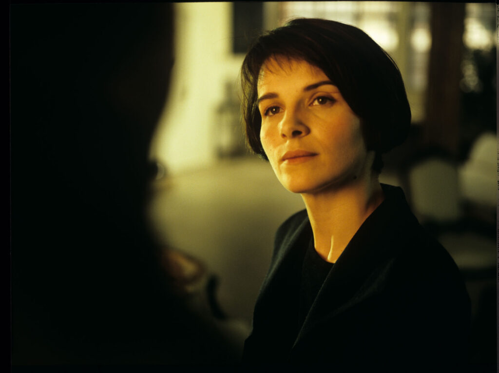 Julie (Juliette Binoche) talks to Olivier (Benoit Regent) in her Parisian residence.