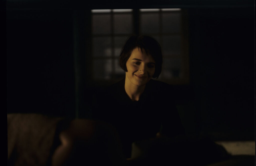 Julie (Juliette Binoche) watches Olivier (Benoit Regent) sleep after spending the night with him.