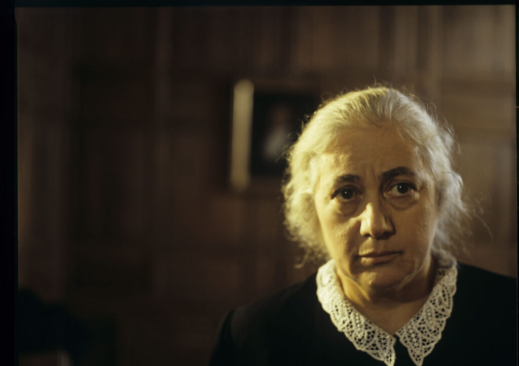 A maid (Isabelle Sadoyan) at the de Courcy estate watches Julie with concern.