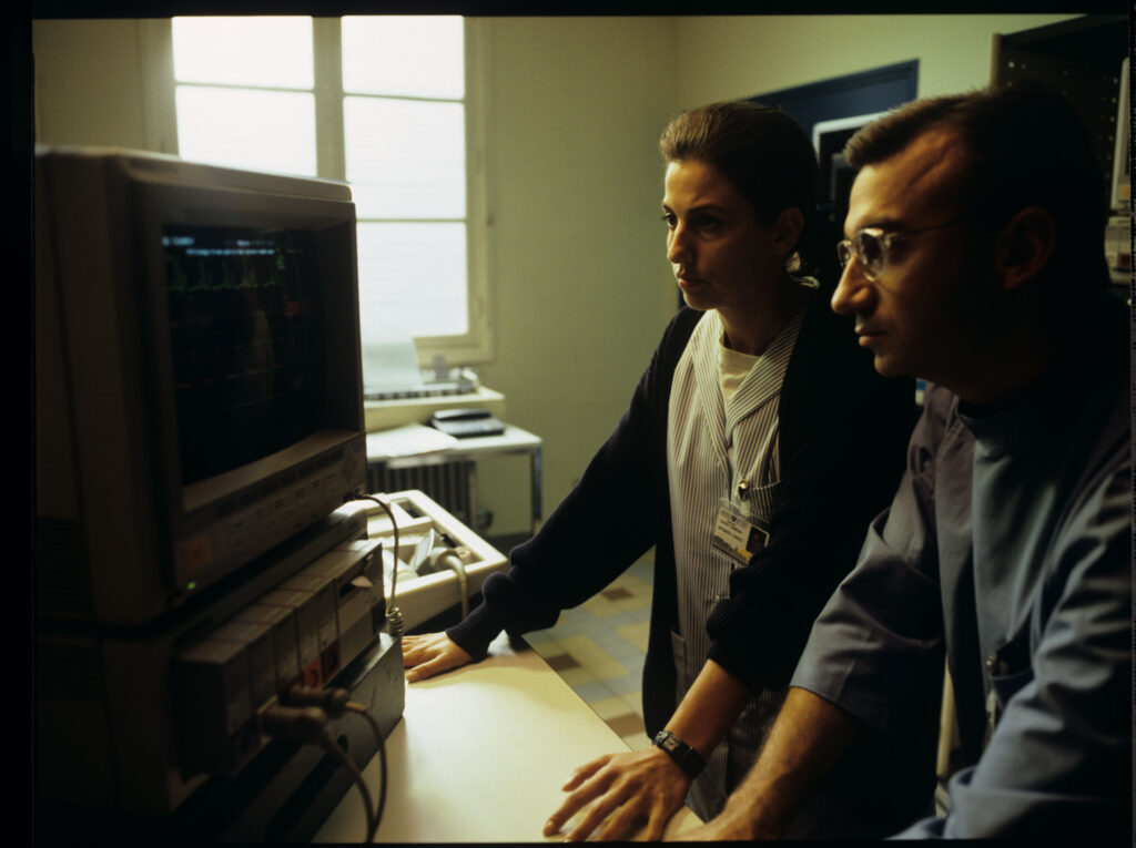 A doctor and a nurse (Idit Cebula) monitor a patient's vital signs in the hospital.