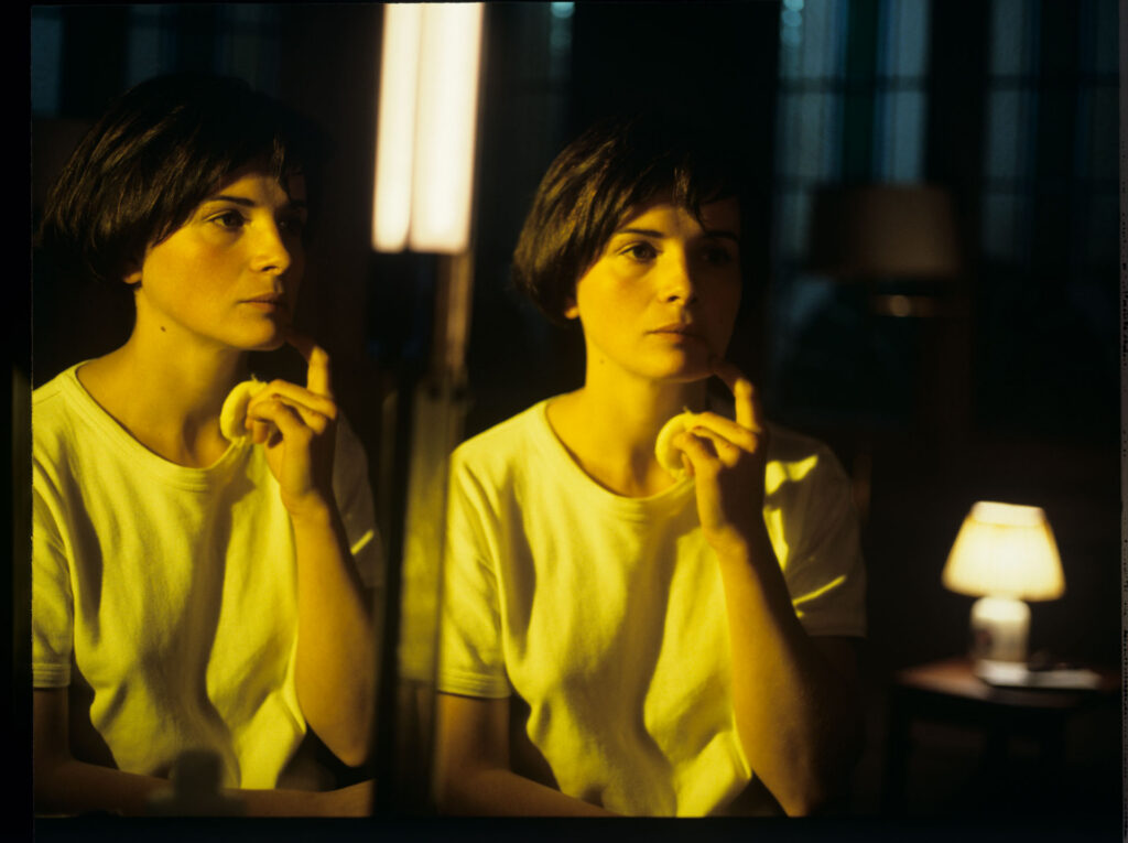 Julie, the main character of the film (Juliette Binoche), looks at her reflection in the mirror.