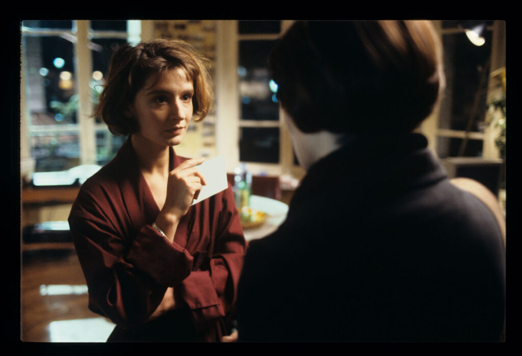 A copyist (Florence Vignon) in her apartment during a visit from Julie (Juliette Binoche).