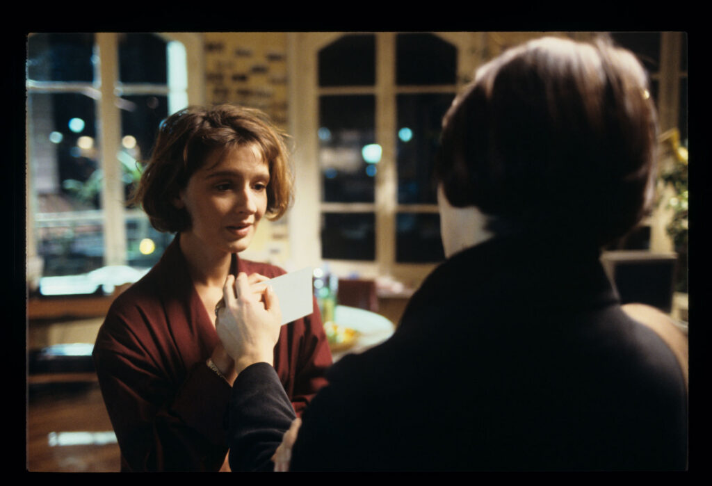 A copyist (Florence Vignon) in her apartment during a visit from Julie (Juliette Binoche).